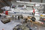 A four-engined transport aeroplane on display in a museum, with other aeroplanes on display in the background.