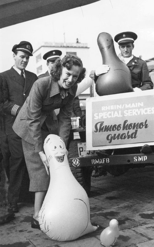 Am Flughafen Rhein/Main präsentieren Piloten und eine Stewardess die aufgeblasenen Shmoo-Luftballons.